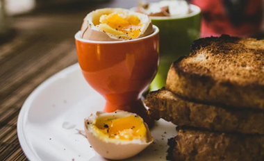Halal half boiled eggs for breakfast served with toast on a plate