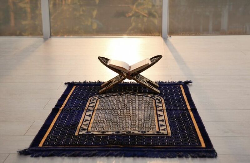 Quran on a prayer mat, ray of light, healing through faith